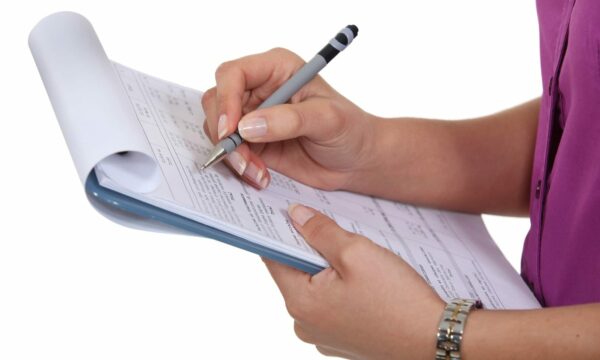 woman writing clipboard