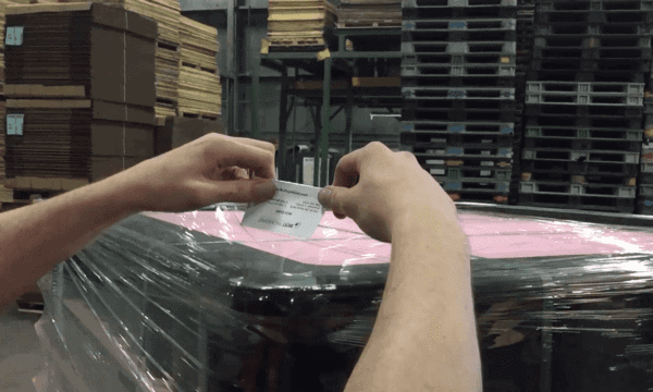 man reading holding a piece of paper